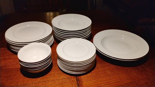 8 place settings +2 serving platters. Missing one small bowl.